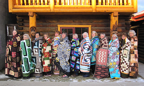 Bear's Paw Quilt staffers wrapped in their quilts